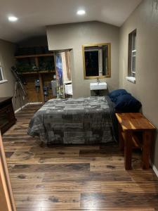 a bedroom with a bed and a wooden floor at Grand Canyon tiny homes in Williams