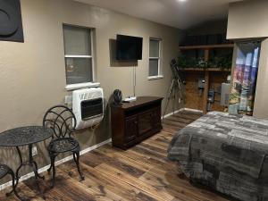 a bedroom with a bed and a table and a tv at Grand Canyon tiny homes in Williams