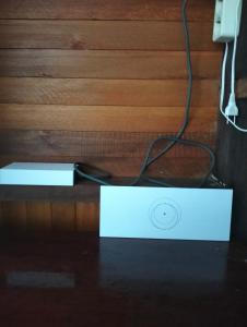 a white box on a table with a cord at Bruno Raja Ampat Homestay in Pulau Mansuar