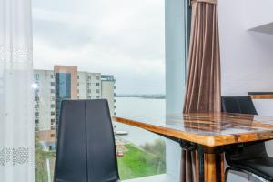a table and chairs in a room with a large window at Hotel Victor in Mamaia