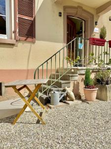 a picnic table in front of a house with stairs at l'Echappée belle Le Duplex 10 min "Europa Park" in Rhinau