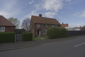 a brick house on the side of a street at The Linwood Terrace in Eastwood