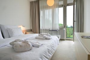 a hotel room with a bed with towels on it at Hotel SOREA MORAVA in Tatranská Lomnica +43 photos