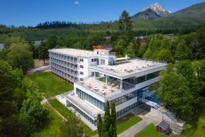 an aerial view of a hotel building with trees at Hotel SOREA MORAVA in Tatranská Lomnica