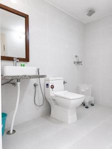 a bathroom with a toilet and a sink and a mirror at Hotel Robin Jaisalmer Near fort view in Jaisalmer