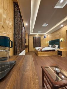 a bedroom with a bed and a sink in a room at The Cedar Pahalgam in Pahalgām