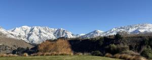 a view of a mountain range with snow covered mountains at Tucker Beach Private Exclusive Retreat in Queenstown