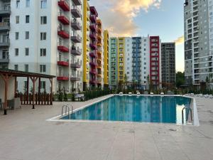 a swimming pool in a city with tall buildings at Charming One-Bedroom Flat in Green Diamond in Tbilisi City