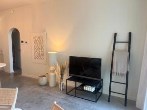 a living room with a flat screen tv on a stand at Villa Rive in Ostend