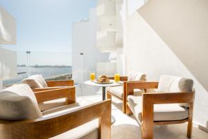 a dining room with chairs and a table with a view at EDEN'S Homes & Villas - FIVE Palm Residences in Dubai