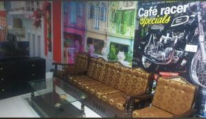 a living room with a couch and a glass table at Hotel Melodyinn in Gujrāt