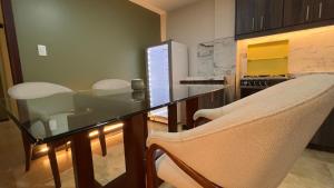 a dining room with a glass table and chairs at Spacious Suite privacy, and comfort in Riobamba
