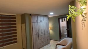a bathroom with a large closet and a toilet at Spacious Suite privacy, and comfort in Riobamba +5 photos
