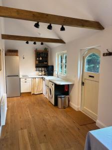 a kitchen with a sink and a refrigerator at Park Cottage cabin in Bix