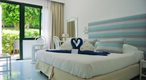 a bedroom with a large bed with a heart on it at Paradiso Terme Resort & SPA con 5 piscine termali in Forio d'Ischia