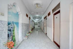 a hallway of a building with plants on the walls at Super Hotel O Gaya Railway Station Formerly Vishal Inn in Gaya