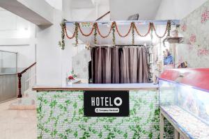 a shop with a hotel sign on the counter at Super Hotel O Gaya Railway Station Formerly Vishal Inn in Gaya