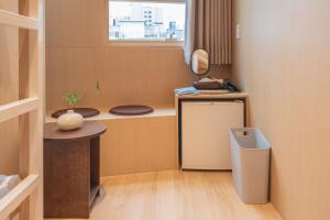 a small kitchen with a sink and a trash can at yulstay in Seoul
