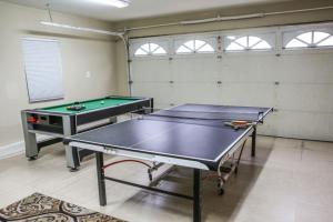 a room with two ping pong tables in it at Wonderful 4 Bedroom 3 Bath Pool Home 3/4 Mile To Disney in Anaheim