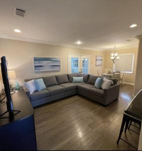 a living room with a couch and a table at Wonderful 4 Bedroom 3 Bath Pool Home 3/4 Mile To Disney in Anaheim