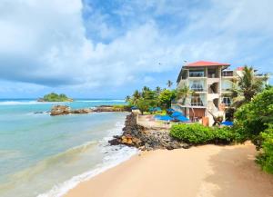 a view of the hotel from the beach at Garton's Cape in Ahangama
