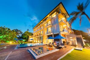 an exterior view of a building with a swimming pool at Garton's Cape in Ahangama