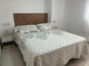 a bedroom with a bed with a quilt on it at Stunning apartment in Oropesa del Mar in Oropesa del Mar +8 photos