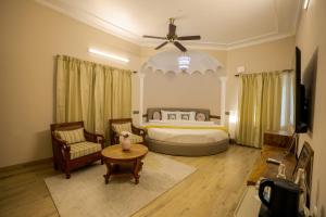 a bedroom with a bed and a ceiling fan at The Mars Sphere in Dehradun