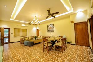 a large living room with a table and chairs at The Mars Sphere in Dehradun