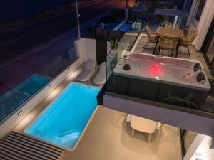 a swimming pool with a hot tub on a house at Ciel Seafront Suites - Maisonette in Lygia