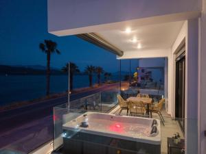 a jacuzzi tub on the balcony of a house at Ciel Seafront Suites - Maisonette in Lygia