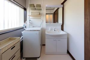 a small bathroom with a sink and a white washer at NASU den-en in Nasu +37 photos