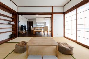 a living room with a table and a dining room at NASU den-en in Nasu