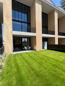 a large grassy yard in front of a building at Villa Rive in Ostend