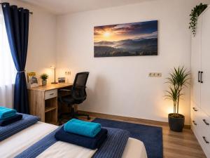 a bedroom with two beds and a desk and a computer at Ferienwohnung Melissa in Unter Feuchten