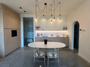 a dining room with a table and a kitchen at Villa Rive in Ostend +6 photos