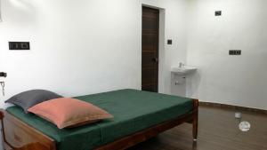 a bedroom with a bed and a toilet at Tranquil Tents in Trivandrum