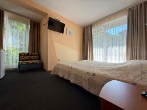 a hotel room with a bed and a large window at Fresh Kiten in Kiten