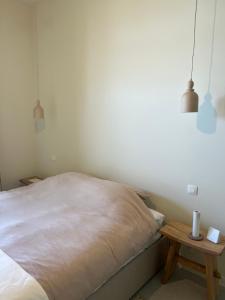 a bedroom with a bed and a wooden table at Villa Rive in Ostend