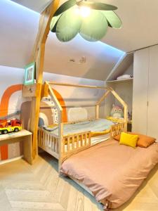 a childs bedroom with a bunk bed and a ceiling at The Gentle Stay in Brunoy