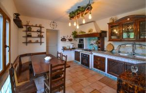 a kitchen with a table and a dining room at Pet Friendly Home In Sinalunga in Sinalunga