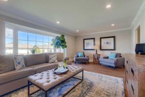 a living room with a couch and a table at Gorgeous Upgraded 5 Bedroom & 3 Bath Home with pool in Orange