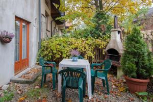 a table and chairs with a table and a fireplace at Pokoje u Karolinki in Zakopane