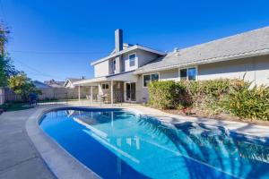 a swimming pool in front of a house at Gorgeous Upgraded 5 Bedroom & 3 Bath Home with pool in Orange