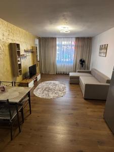 a living room with a couch and a table at Signature Studio Arad in Arad