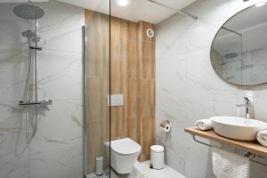 a bathroom with a shower and a toilet and a sink at Bile - Family Hotel & Gastro Bar in Beli Osŭm