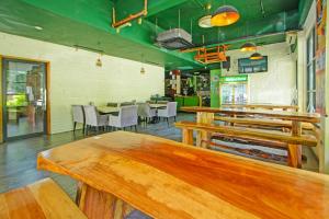 a dining room with wooden tables and chairs at Townhouse Near Tanjung Batu Formerly 900 Inn in Bintulu