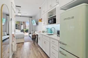 a kitchen with a sink and a refrigerator at Bluehavenon30a-Between Rosemary & Alys Beach -Steps to Beach & Dining-Sleeps 3 in Rosemary Beach