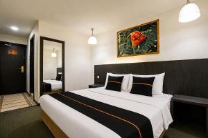 a bedroom with a large bed in a hotel room at Townhouse Near Tanjung Batu Formerly 900 Inn in Bintulu