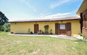 a small yellow house with a yard in front of it at Umbria Montefranco in Montefranco